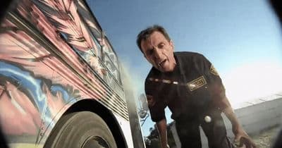 a man standing next to a van with graffiti on it