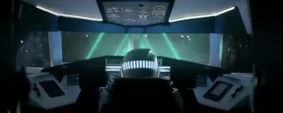 a man sitting in a spaceship looking out the window