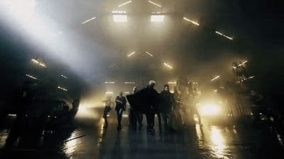 a group of people standing in a dark room