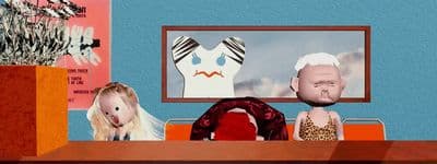 a couple of dolls sitting on top of a wooden table