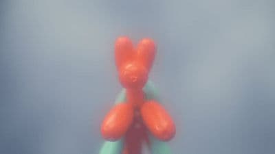a red teddy bear sitting on top of a green object