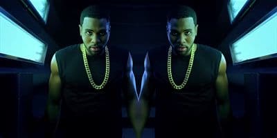 a man in a black shirt with a chain around his neck