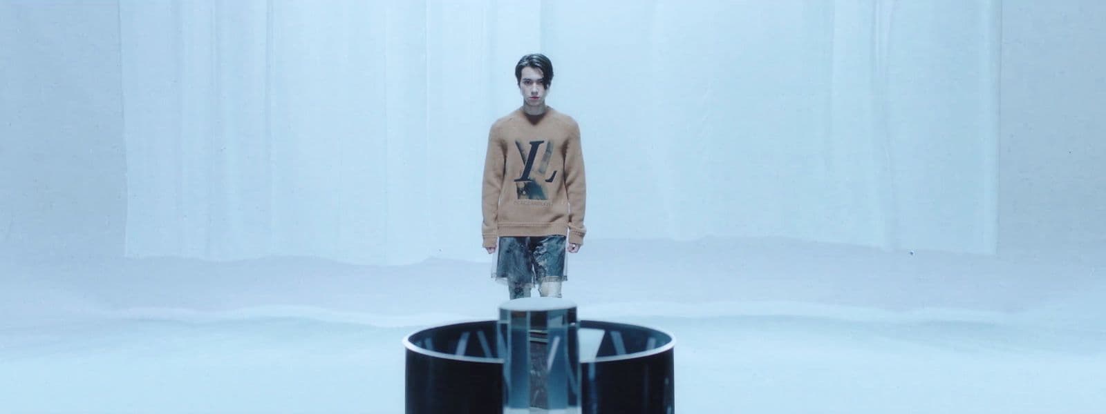 a man standing in front of a round object