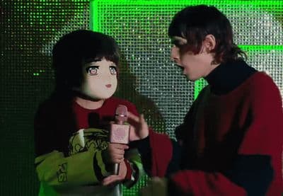 two people standing next to each other talking