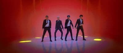 a group of men standing on top of a stage