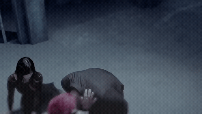 a man kneeling down next to a woman in the snow