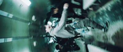 a man riding a skateboard through a tunnel