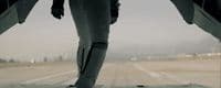 a person standing on a runway with their feet in the air