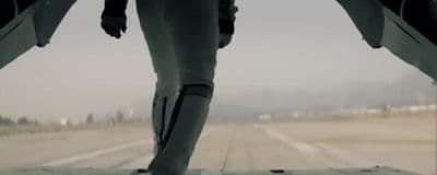a person standing on a runway with their feet in the air