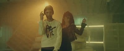 a man standing next to a woman in a room