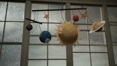 a mobile with planets and stars hanging from it
