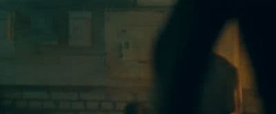 a blurry image of a person standing in front of a building
