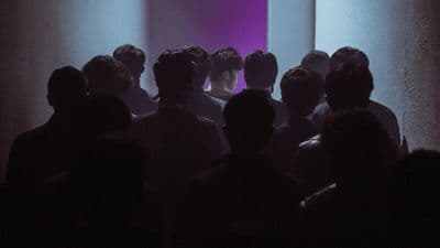 a group of people standing in a dark room
