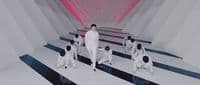 a group of men standing on top of a white and black striped floor