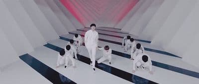 a group of men standing on top of a white and black striped floor