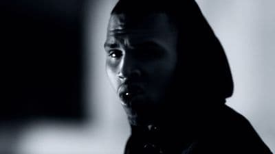 a man in a hoodie making a face