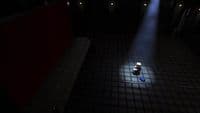 a person sitting on a floor in a dark room