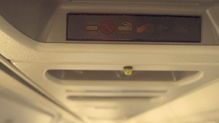 a sign on the ceiling of an airplane