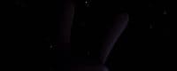 a person standing in the dark with their feet in the air