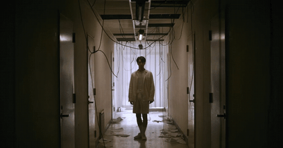 a person walking down a hallway in a building