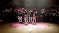 a group of people standing on top of a basketball court