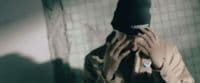 a person covering their face with a hat