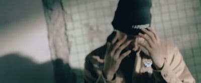 a person covering their face with a hat