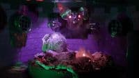 a strange looking statue in a dark room