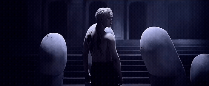 a man standing in front of a bunch of white balls