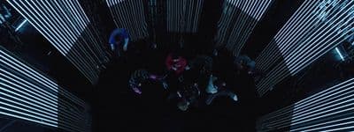 a group of people standing in the middle of a room