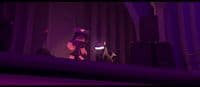 a man standing on top of a stage next to a speaker