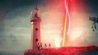 a group of people standing on top of a red and white lighthouse