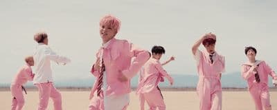 a group of young men in pink outfits