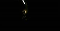a person standing in the dark with a light on