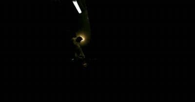 a person standing in the dark with a light on