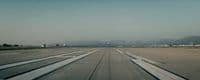 an airport tarmac with several planes parked on it
