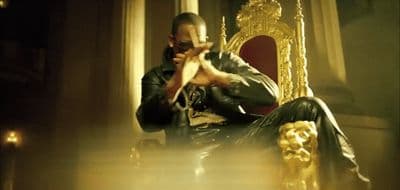 a man sitting on top of a golden chair