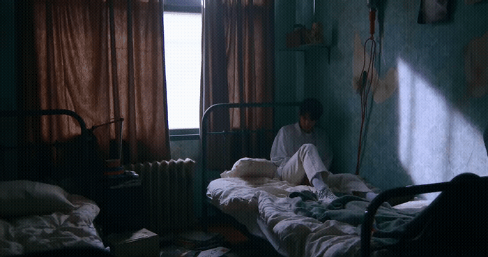 a person sitting on a bed in a room