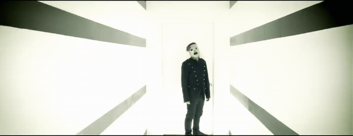 a man standing in front of a white wall