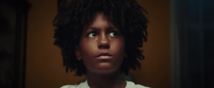 a close up of a person with curly hair
