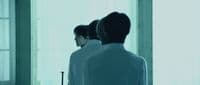 a man standing in front of a mirror in a room
