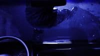 a car dashboard with a person in the background