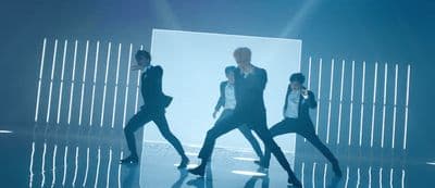 a group of men standing on top of a stage