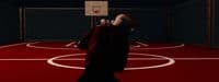 a man standing on a basketball court holding a basketball
