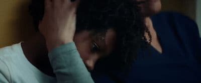 a woman holding her hair in front of her face