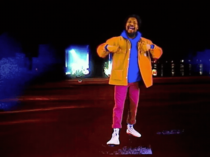 a man in a yellow jacket and pink pants