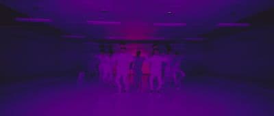 a group of people standing in a dark room