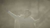 a man with his arms outstretched in the air