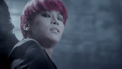 a person with pink hair and piercings on