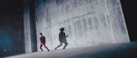 a couple of people that are walking down a street